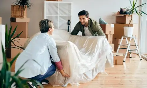 Happy couple moving into their new apartment