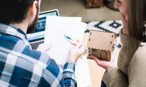 couple reviewing documents, possibly related to real estate